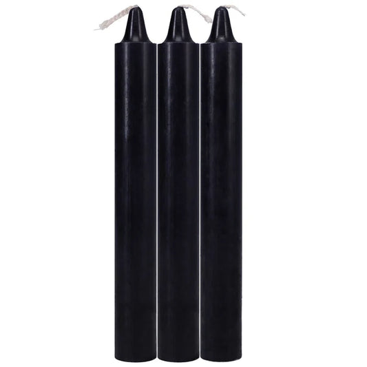 Three black candles on a white background