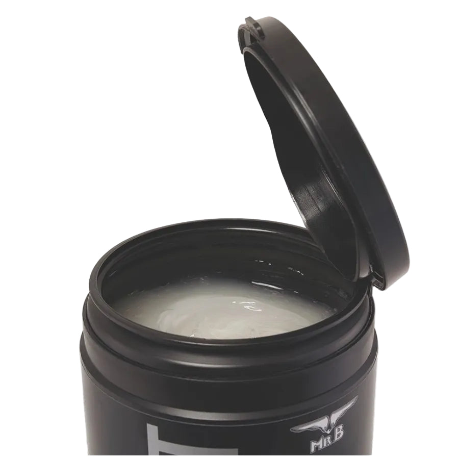 Black container with lid open, revealing a white substance inside on a white background