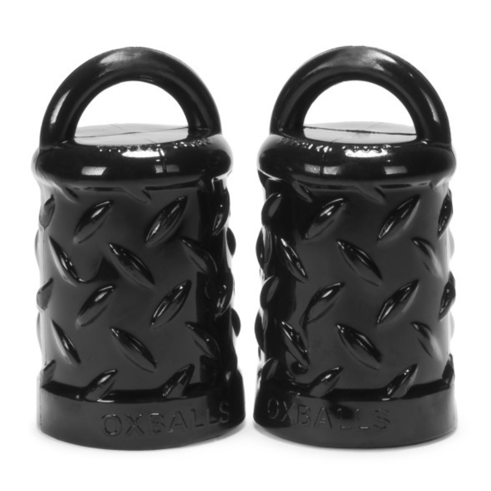 Two black textured weight plates with 'OXBALLS' branding on a white background
