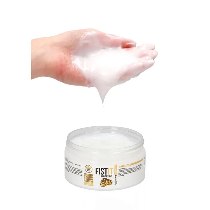 Hand holding a white cream above a jar labeled 'FIST' on a white background