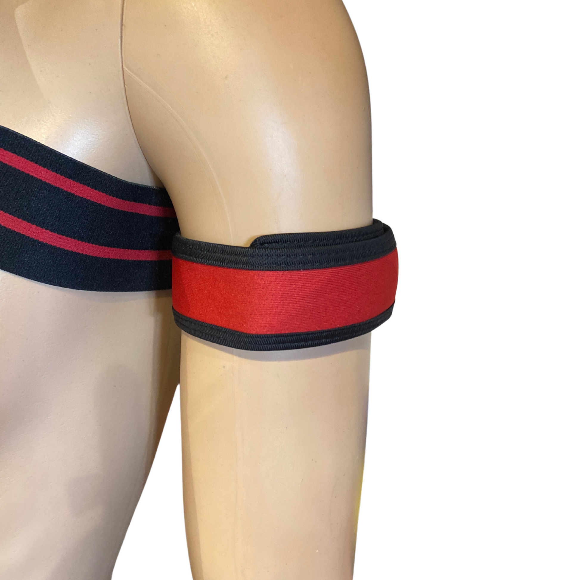 Red and black band on a mannequin arm against a white background